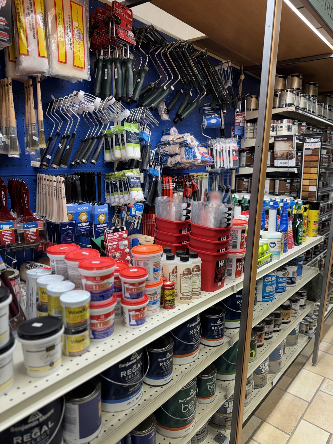 Spackle, fillers, cleaners, and Benjamin Moore paint on the shelves